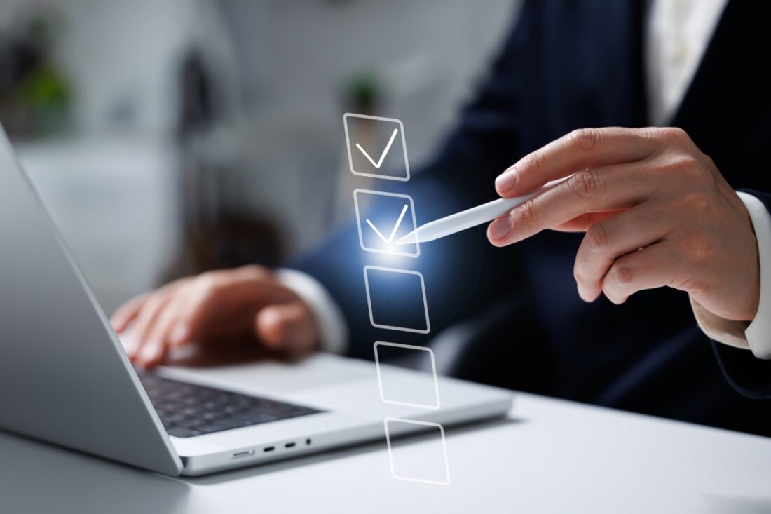 A,Businessman,Sits,At,His,Laptop,,Using,A,Pen,To